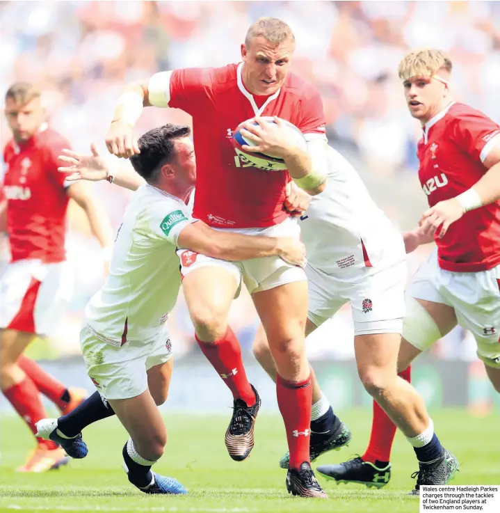  ??  ?? Wales centre Hadleigh Parkes charges through the tackles of two England players at Twickenham on Sunday.