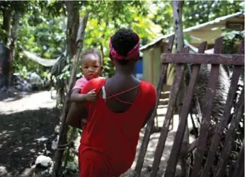  ?? DIEU NALIO CHERY/THE ASSOCIATED PRESS ?? Janila Jean, 18, and her daughter. Jean said a UN peacekeepe­r raped her at gunpoint and left her pregnant.