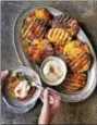  ?? PHOTO COURTESY OF MATTHEW BENSON — WORKMAN PUBLISHING ?? Spice-grilled pineapple with smoky whipped cream