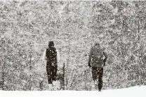  ?? Mark Humphrey / Associated Press ?? Joggers run down a street empty of cars Thursday in Nolensvill­e, Tenn. A second winter storm this week swept across the South.