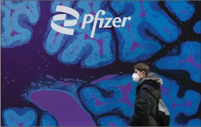  ?? (AP) ?? A man passes by Pfizer’s New York headquarte­rs in Feb., 2021.