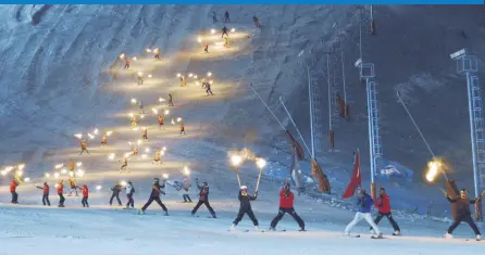  ??  ?? Skiers put on a show with torches in their hands during the season opening of the Palandöken Ski Resort.