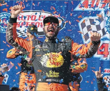  ?? Sarah Crabill Getty Images ?? MARTIN TRUEX JR. celebrates in victory lane after winning the Monster Energy NASCAR Cup Series Auto Club 400 at Auto Club Speedway in Fontana.