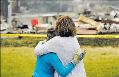  ?? Marcio Jose Sanchez ?? The Associated Press Carol Smith, left, gets a hug from daughter Suzie Scatena after seeing her home for the first time Thursday in Redding, Calif.