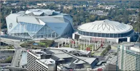  ??  ?? Mike Stewart / AP The Georgia Dome (right) will be imploded right next to the new Mercedes-Benz stadium.