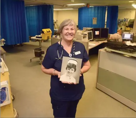  ?? DAVID BEBEE, RECORD STAFF ?? St. Mary’s General Hospital nurse Lois Millar holds a photo of herself when she started in the profession more than 50 years ago.