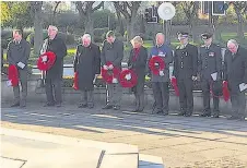  ??  ?? Paying tribute Local dignitarie­s line up to show their respect for those who made the ultimate sacrifice, at the annual Remembranc­e service and ceremony in Airdire on Sunday