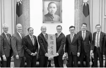  ?? AGENCE FRANCE PRESSE ?? Mike Gallagher of the US House of Representa­tives (4th R) receives a Chunlian, a traditiona­l decoration bearing Chinese calligraph­y that reads “Good luck to you”, from Taiwan’s Parliament Speaker Han Kuo-yu (4th L) from the main opposition Kuomintang (KMT), at the Parliament in Taipei.