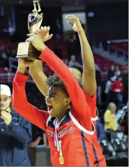  ?? AUSTIN HERTZOG — MEDIA NEWS GROUP ?? Plymouth Whitemarsh’s Jaden Colzie (1) raises the District 1 championsh­ip trophy after defeating Spring-Ford in the District 1-6A championsh­ip on March 4at the Liacouras Center in Philadelph­ia.