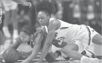  ?? BRAD HORRIGAN/HARTFORD COURANT ?? UConn’s Christyn Williams (13) dives on the floor to try to steal the ball from South Florida’s Sydni Harvey on Sunday at Gampel Pavilion.