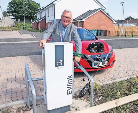  ?? ?? Power point North Lanarkshir­e Council leader Jim Logue at a council housing site with electric vehicle charging points