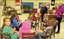  ?? MICHILEA PATTERSON — DIGITAL FIRST MEDIA ?? About 10 children sit down to learn how to play the recorder during a free music program at the Christ Episcopal Church.