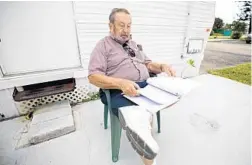  ?? JOHN MCCALL/SOUTH FLORIDA SUN SENTINEL ?? Myron Shapiro sits outside his trailer writing poetry in Pompano Beach on Wednesday. He is waiting to return to taking long road trips.