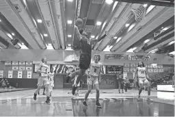  ?? MEGAN MENDOZA/THE REPUBLIC ?? Gilbert Perry sophomore small forward Koa Peat rises for a dunk during a game against Eastmark in the Welcome to the Jungle holiday tournament on Monday in Gilbert.