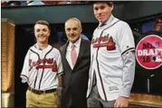  ?? AP ?? Carter Stewart (right), a high school pitcher from Florida, poses with MLB Commission­er Rob Manfred and Luke Terry (one-armed catcher and Braves fan) after being selected eighth by the Braves in the first round in June.