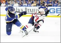  ?? (AP) ?? St Louis Blues’ Tyler Bozak (left), scores past Washington Capitals’ Carl Hagelin, of Sweden, during the second period of an NHL preseason
hockey game on Sept 27 in St Louis.