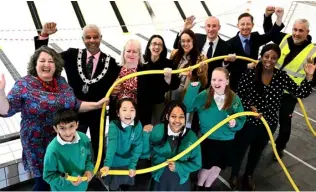  ?? ?? READY TO BE FILLED: Students from Oxford Road Community School with councillor­s and representa­tives from GLL Leisure and Pellikaan UK celebrate the start of filling the new swimming pool at Rivermead Leisure Centre