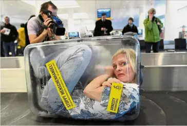  ??  ?? Abolishing modern day slavery: In this file photo taken in an airport, a woman is locked up in a transparen­t suitcase with a sign on it reading ‘ Stop Human Traffickin­g!’ as part of a campaign to highlight the human rights declaratio­n.