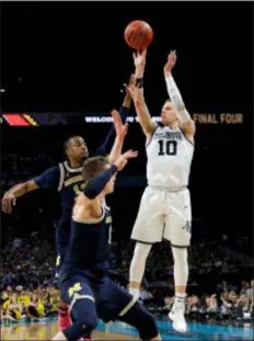  ?? DAVID J. PHILLIP — THE ASSOCIATED PRESS FILE ?? Villanova’s Donte DiVincenzo takes a shot against Michigan during the NCAA final in April. The underclass­men is a likely first-round pick in Thursday’s NBA draft.
