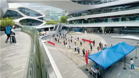  ?? Photo: AP ?? People queue for PCR tests in Beijing yesterday where authoritie­s are hoping to avoid the sort of lockdowns being experience­d by the population of Shanghai.