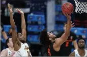  ?? JEFF ROBERSON — THE ASSOCIATED PRESS ?? Oregon State guard Ethan Thompson (5) drives to the basket ahead of Loyola Chicago guard Marquise Kennedy (12) during the second half of a Sweet 16 game in the NCAA Tournament at Bankers Life Fieldhouse on Saturday in Indianapol­is.
