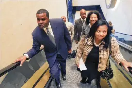  ?? BOB ANDRES / AJC 2011 ?? Former Atlanta Mayor Kasim Reed (left) arrives at the Commerce Club in December 2011 for a meeting with an attorney. Reed donated $77,000 to the city as his term expired in December 2017, including $40,000 to a dormant nonprofit.