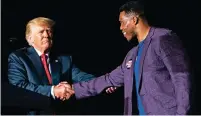  ?? DEMETRIUS FREEMAN/WASHINGTON POST FILE PHOTO ?? Former President Donald Trump shakes hands with Georgia Senate candidate Herschel Walker at a September 2021 rally in Perry, Ga. Walker’s loss in this week’s runoff election has further isolated Trump from his party.