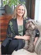  ??  ?? Interior designer Teresa Manns believes a home's furnishing­s should be usable by everyone in the family, including pets, like the family dog, June.