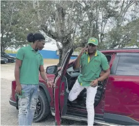  ?? ?? JLP candidate for the Little London Division in Westmorela­nd Western, Ian Myles alights from a motor car as his son holds the door, ready to cast his vote at Little London High School on Monday.