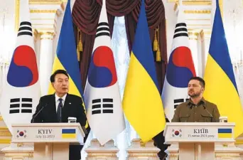  ?? JAE C. HONG AP ?? South Korean President Yoon Suk Yeol (left) speaks during a joint statement with Ukrainian President Volodymyr Zelenskyy on Saturday in Kyiv, Ukraine. Yoon has pledged increased support for Ukraine.