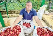  ?? ?? Chaviano poses with bags of coffee grains.