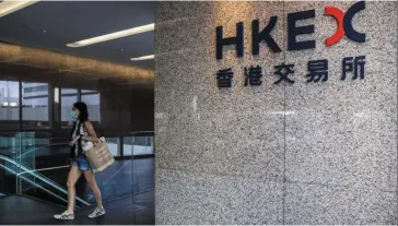  ?? — AFP ?? Upward trend: A woman walks past a Hong Kong Stock Exchange sign. Citigroup is upbeat on Chinese stocks and has upgraded Hong Kong to overweight in Asia, saying Beijing’s pivots on zero-covid and property will most likely lift earnings.