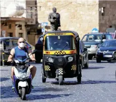  ?? ?? A tuktuk taxi drives on a street in the Lebanese city of Batroun north of the capital. — AFP