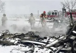  ?? SEAN MURPHY/ AP ?? Firefighte­rs put out a hot spot from the Smokehouse Creek fire in Stinnett, Texas on Thursday. A wildfire spreading across the Texas Panhandle became the largest in state history Thursday, as a dusting of snow covered scorched prairie, dead cattle and burned out homes and gave firefighte­rs a brief window of relief.