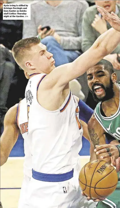  ??  ?? Kyrie Irving is stifled by Kristaps Porzingis and Enes Kanter as Knicks stuff Celtics Thursday night at the Garden.