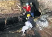  ?? JOSE M. OSORIO/ CHICAGO TRIBUNE ?? Lynne Gonzalez, 56, of Prairie du Rocher, sits on the ground as she and her family hike in the reopened Illinois Caverns in Waterloo on July 15.