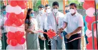  ??  ?? Bussiness Developmen­t Regional Manager Salinda Deegalla cuts ribbon while Regional Manager Recoveries Hemantha Hettiarach­chi (right) and Head of Branch Vajira Abeysinghe look on