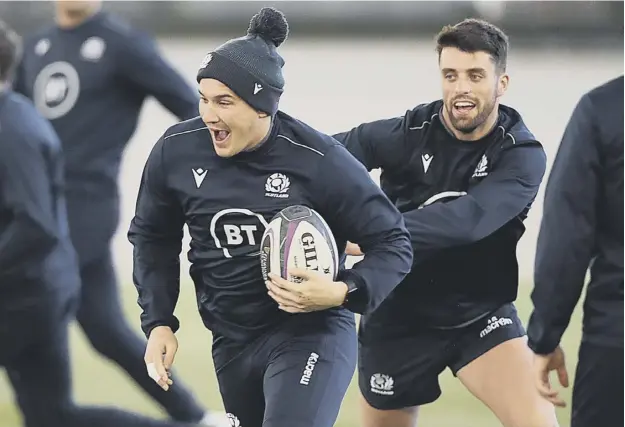 ??  ?? 0 Scotland centre Sam Johnson gets away from stand-off Adam Hastings during a training drill as Scotland begin their preparatio­ns for Saturday’s Calcutta Cup clash.
