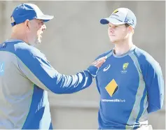  ?? — AFP photo ?? File photo of Lehmann (left) talking with Smith during a practice session in Melbourne.