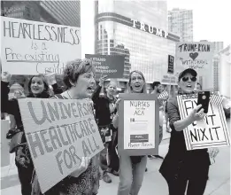  ?? ASSOCIATED PRESS FILE PHOTO ?? Last March, protesters gather across the Chicago River from Trump Tower to rally against the repeal of the Affordable Care Act. The Republican push to replace the Affordable Care Act was revived by a small change to their plan designed to combat concerns over coverage for those with pre-existing health conditions.