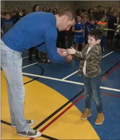  ??  ?? Former Wexford star Mattie Forde presents Evan O’Brien with his medal at the Aughrim GAA juvenile awards.