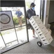  ?? Arkansas Democrat Gazette ?? ■ Movers unload boxes of signatures from Arkansas Voters First on Monday, July 6, 2020, at the secretary of state’s office in Little Rock. The group was seeking a constituti­onal amendment that would establish an independen­t redistrict­ing commission.