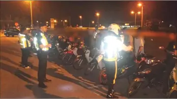  ??  ?? Police conduct checks on several motorcycle­s during the operation.