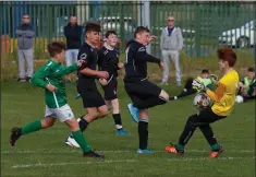  ??  ?? Wicklow Rovers goalkeeper Eoghan Doyle does well to deny Arklow’s Jack McCarthy.