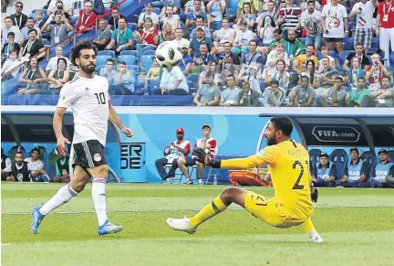  ?? /ROBBIE JAY BARRATT - AMA/GETTY IMAGES ?? Mohamed Salah scores Egypt’s first World Cup from open play since 1934 in their clash against Saudi Arabia at Volgograd Arena yesterday. Saudi Arabia won 2-1.