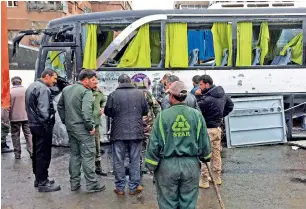  ?? Reuters ?? Syrian army soldiers and civilians at the site of the attack in Damascus on Saturday. —