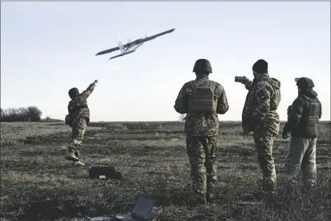  ?? LIBKOS VIA AP ?? UKRAINIAN SOLDIERS LAUNCH A DRONE AT RUSSIAN POSITIONS near Bakhmut, Donetsk region, Ukraine, on Thursday.