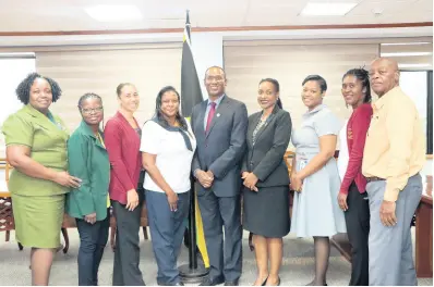  ?? CONTRIBUTE­D ?? Nigel Clarke (centre), minister of finance and the public service, pose with Marsha Smith (fourth right), state minister; Debra Treasure (fourth left), president of the Council of Paramedics; Esther Campbell (left), president of the Jamaica Enrolled Assistant Nurses Associatio­n; Sharon Banbury-edwards (third left), first vice-president of the Jamaica Midwives’ Associatio­n, and other executive members last Wednesday.