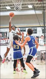  ?? Tim Godbee ?? Calhoun sophomore Makadan Griffin rises above a pair of Cass defenders for a shot Wednesday night at The Hive.