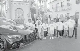  ?? KARA STARZYK ?? Teddy Morse, Brian Quail, Hélio Castroneve­s, Rick and Rita Case, William Lehman, Paula Levenson, Lee Josephson and Peter Gary with children from the Boys & Girls Clubs of Broward County. The 14th annual Boca Raton Concours d’Elegance takes place Feb. 7-9 at the Boca Raton Resort & Club to benefit the Boys & Girls Clubs of Broward County.